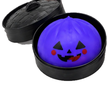 Purple pumpkin dumpling squishy in its black container